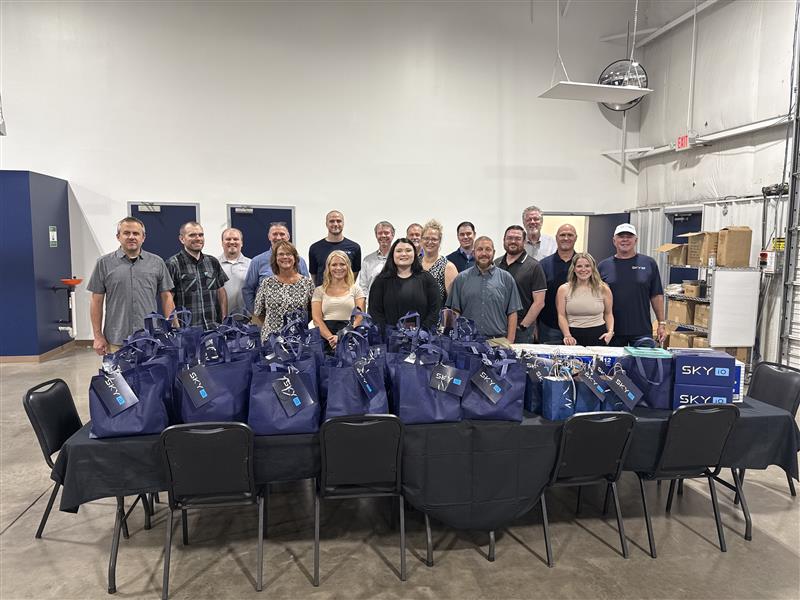 Group of Team Members in Warehouse with branded bags for Back to School
